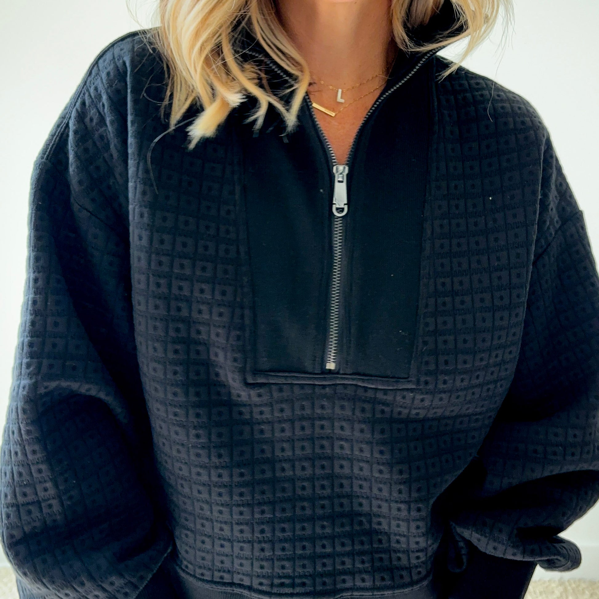 Women's black geometric patterned quarter zip pull over sweatshirt