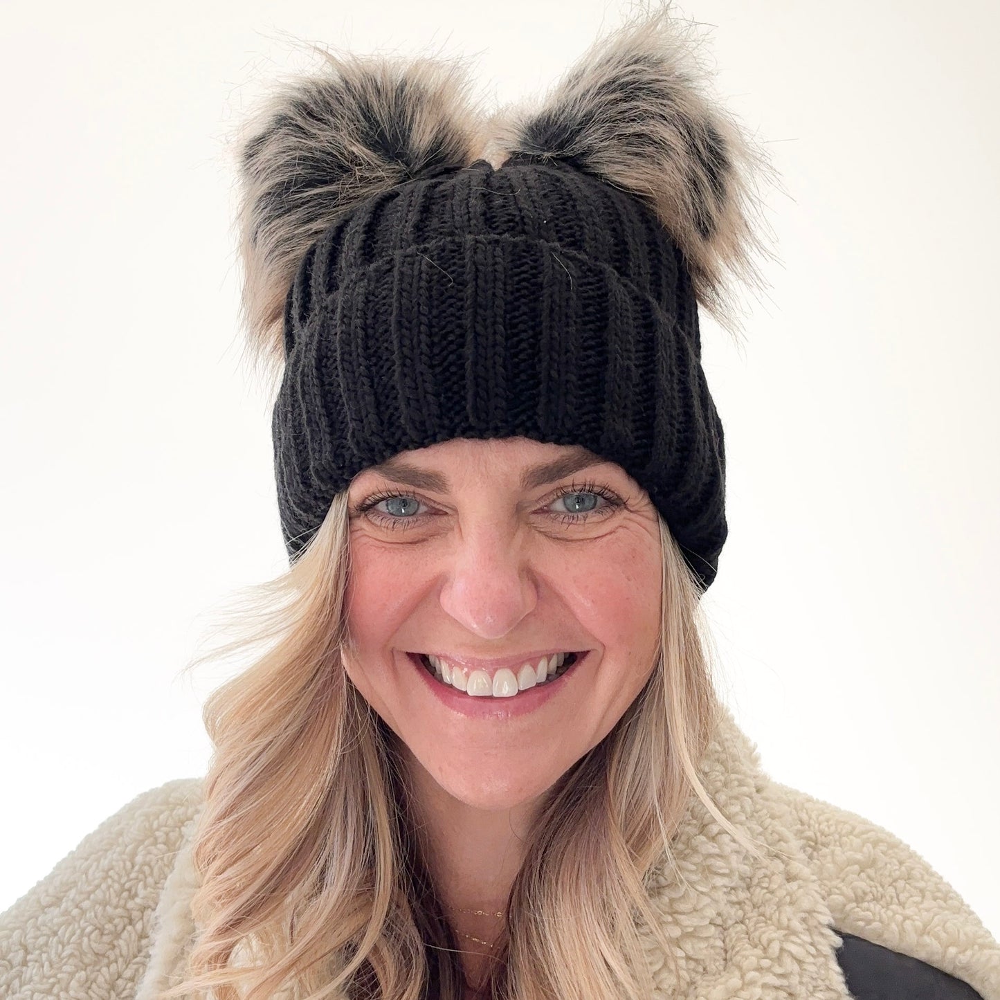 Black rib knit beanie with cuff and double pom poms