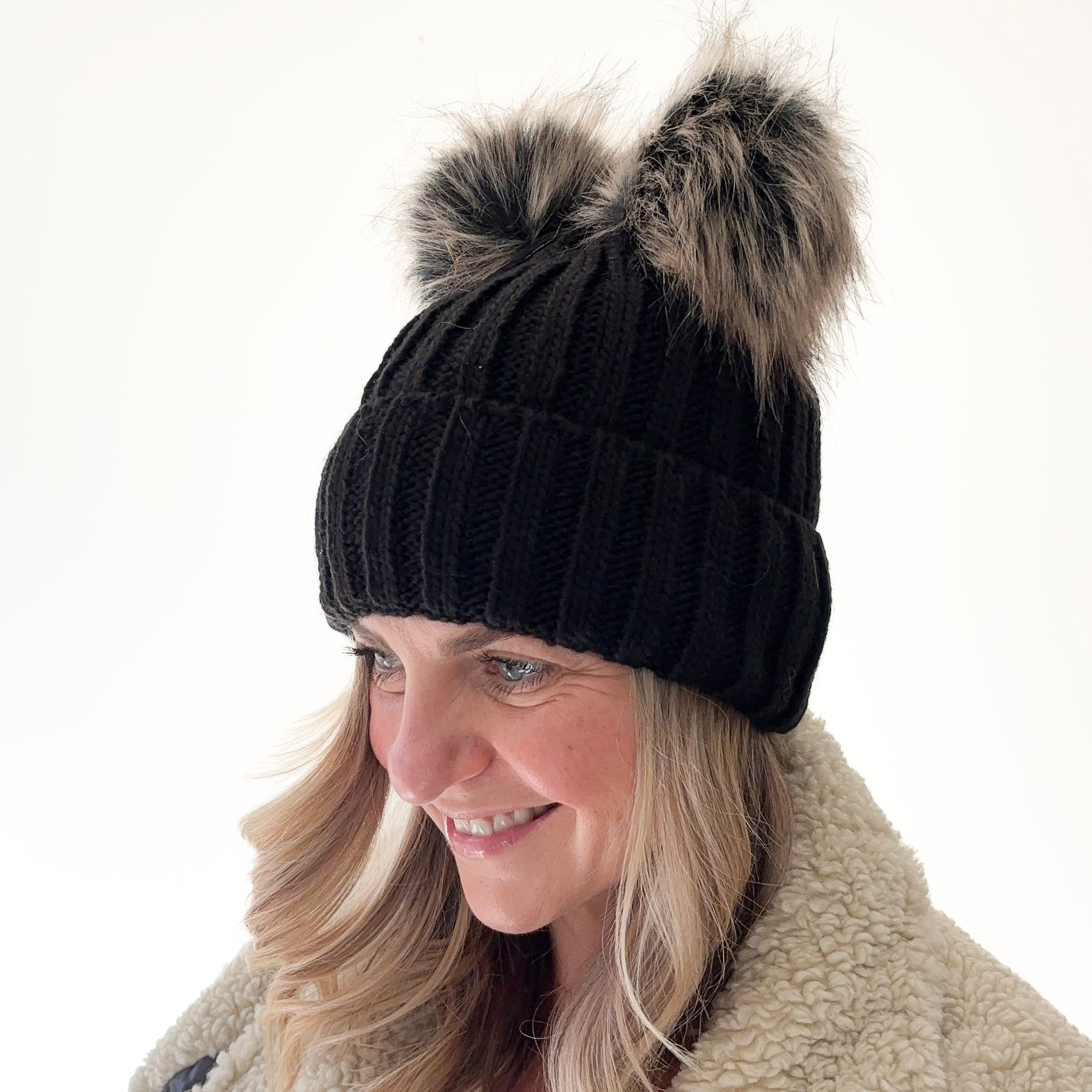 Black rib knit beanie with cuff and double pom poms