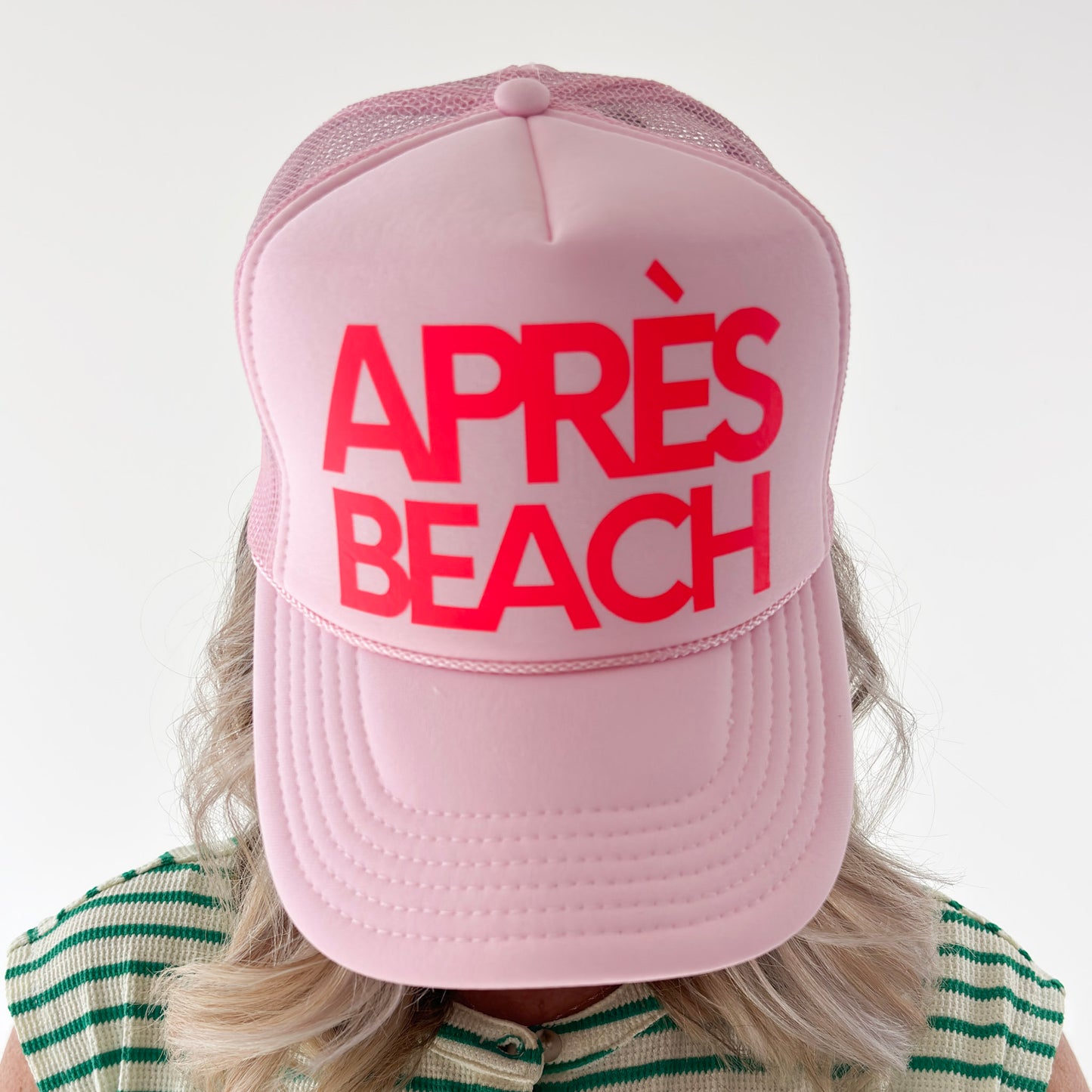 Women's light pink high profile trucker hat with neon coral après beach print