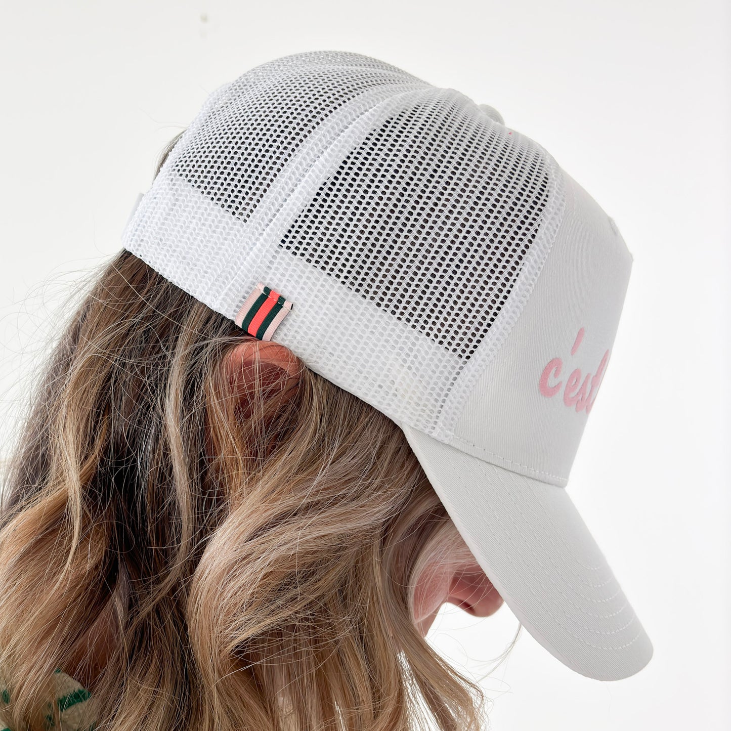 White cotton twill high profile snap back trucker hat with light pink script "c'est le pckl" pickleball hat