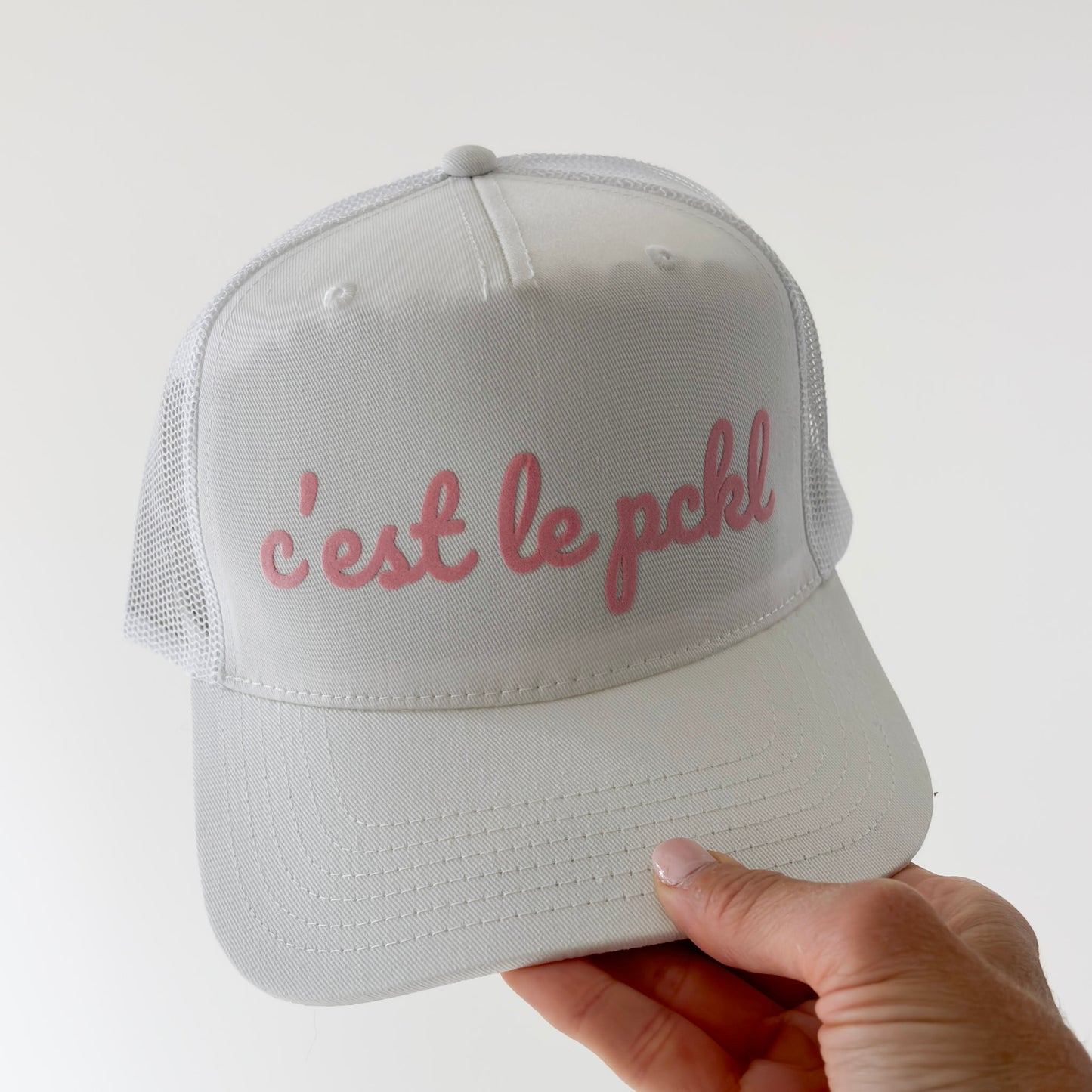 White cotton twill high profile snap back trucker hat with light pink script "c'est le pckl" pickleball hat