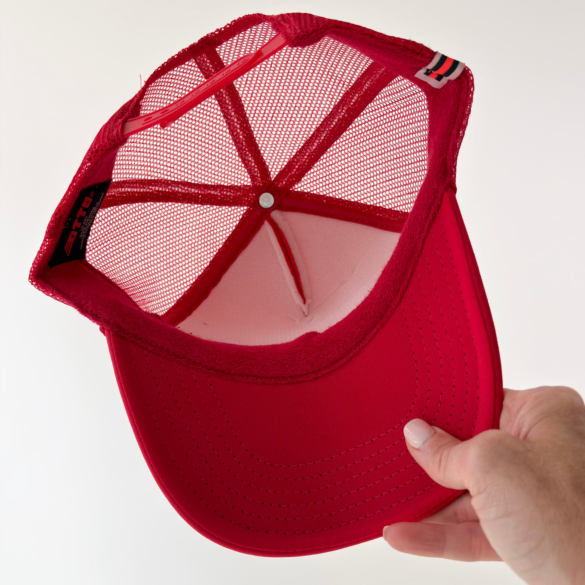 Women's bright red foam mid profile snap back trucker hat with blue bikinis & martinis. graphic