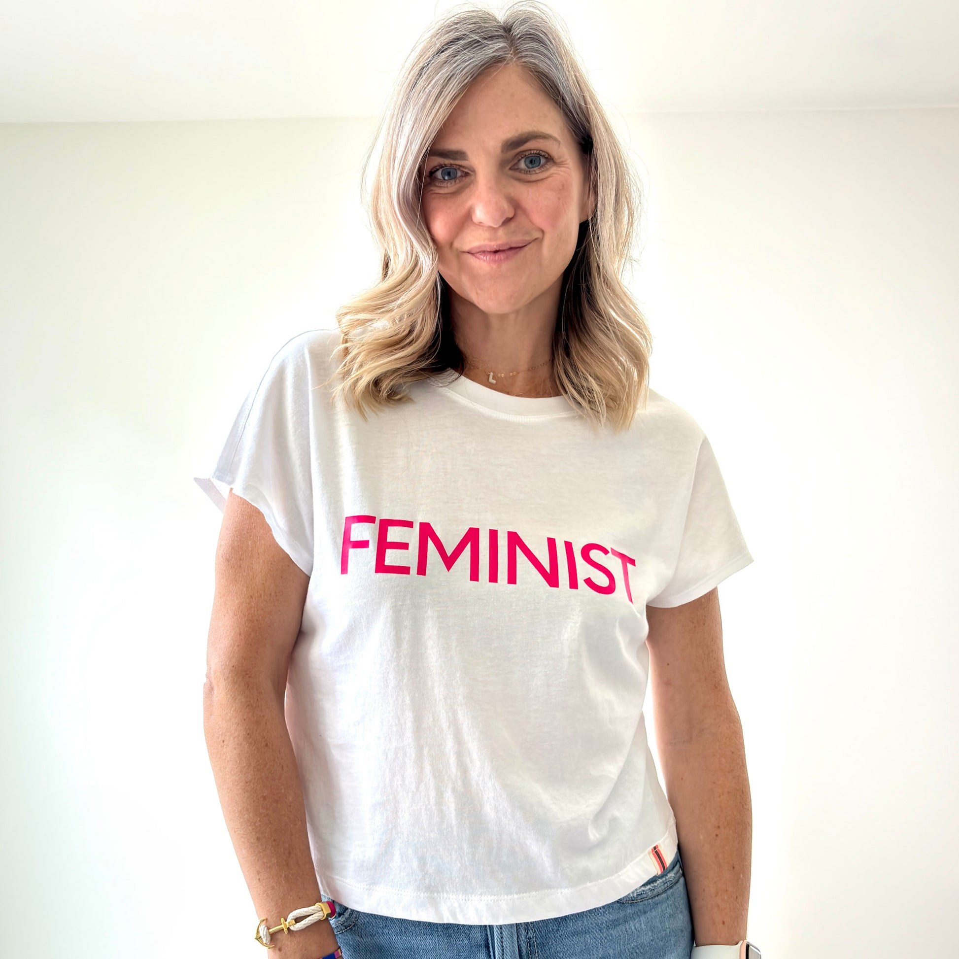 women's white short sleeve t shirt with neon pink feminist print