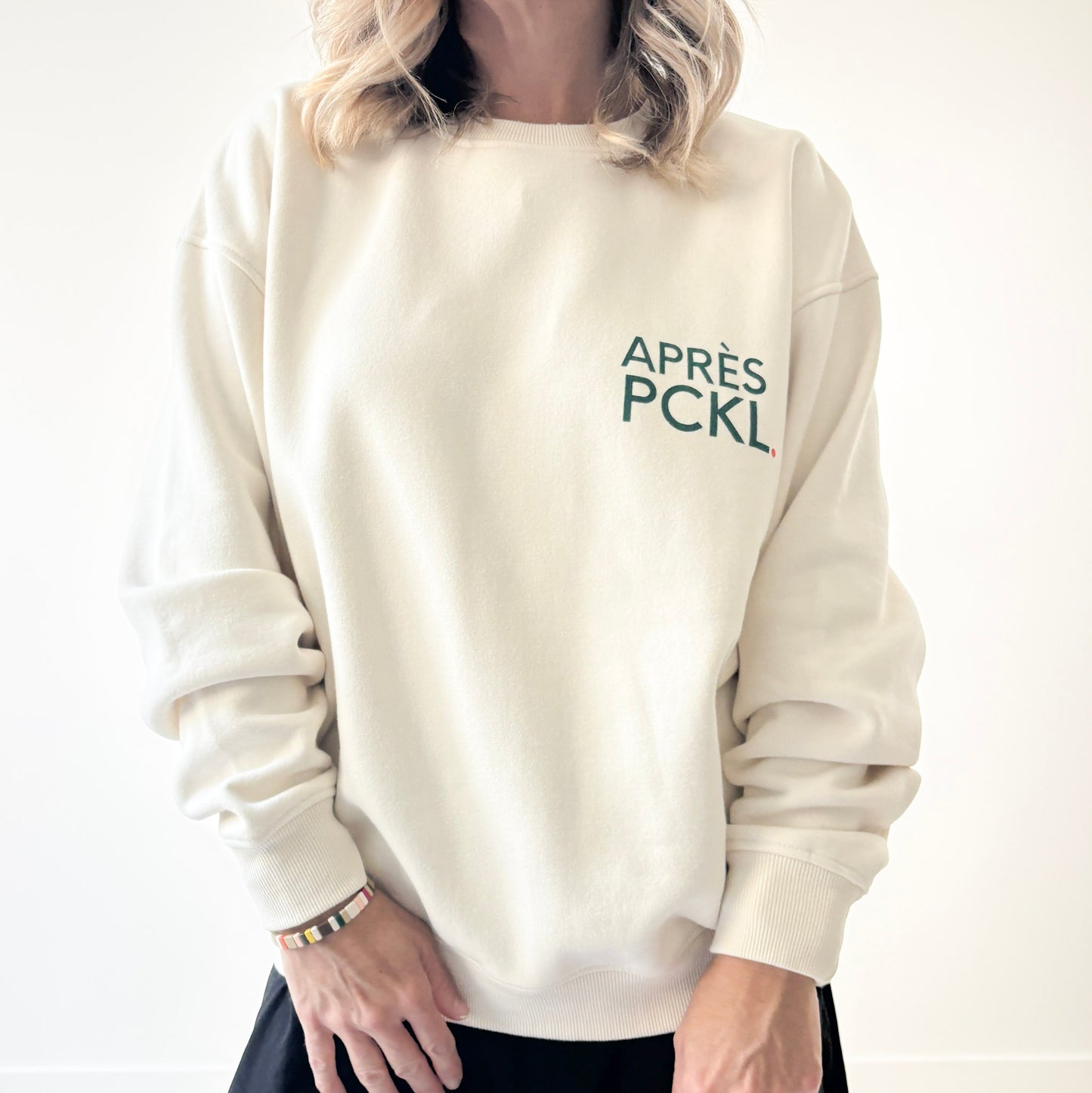 Ivory crew neck fleece sweatshirt with dark green après pckl. pickleball chest print 