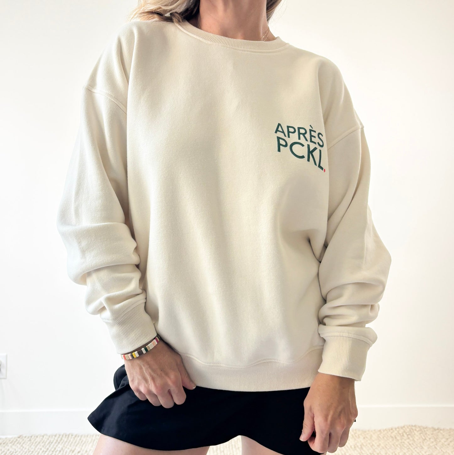 Ivory crew neck fleece sweatshirt with dark green après pckl. pickleball chest print