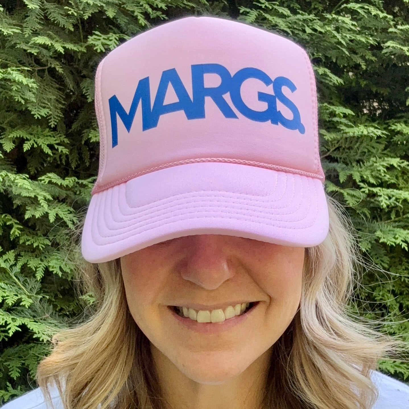 Women's light pink high profile trucker hat with bright blue margs. print graphic