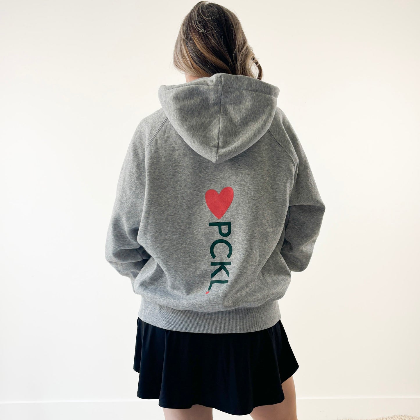 Heather grey full zip hooded sweatshirt with back print coral heart and dark greenpckl. pickleball graphic