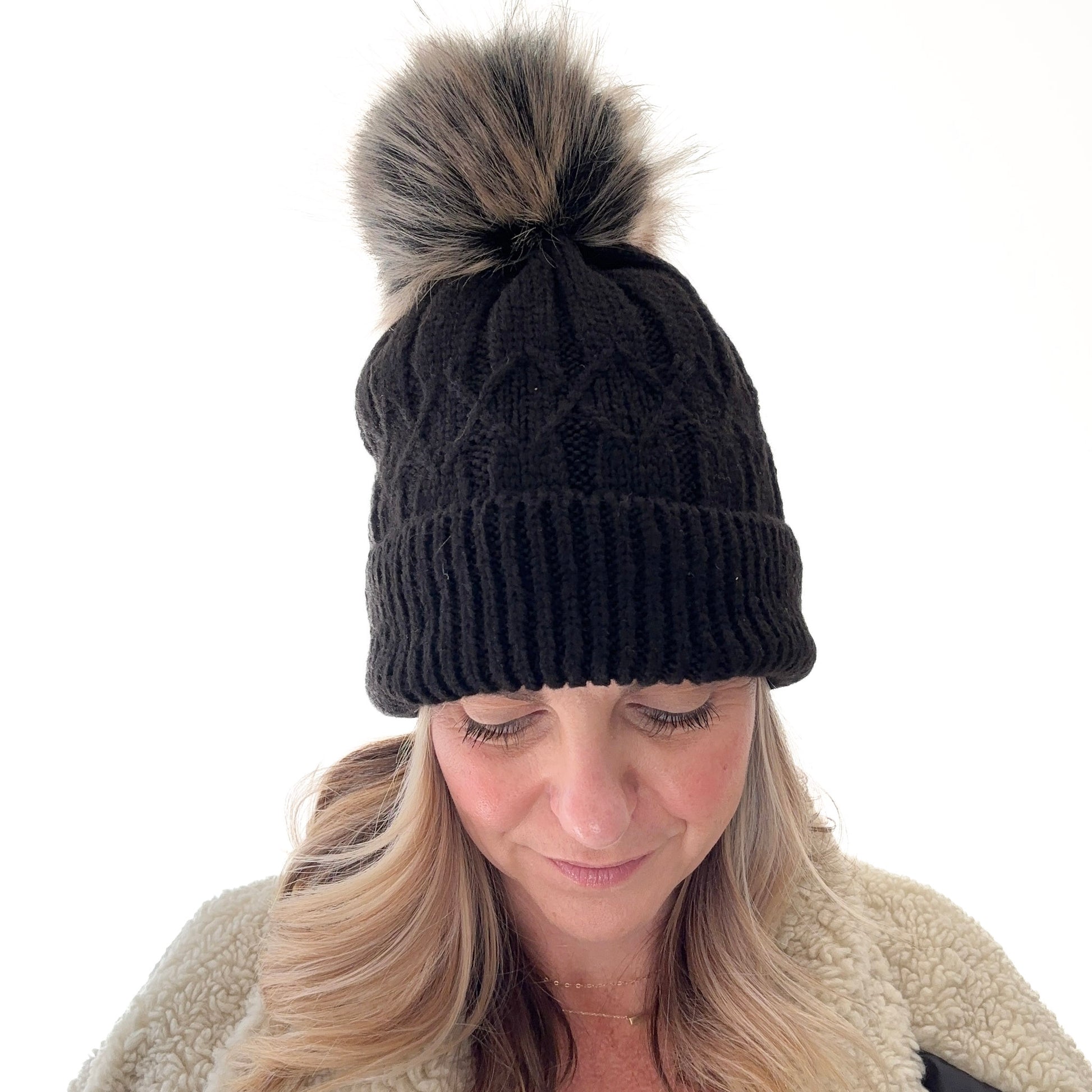 Black cuffed beanie with fair isle knit, ribbed cuff and black with tan oversized pom