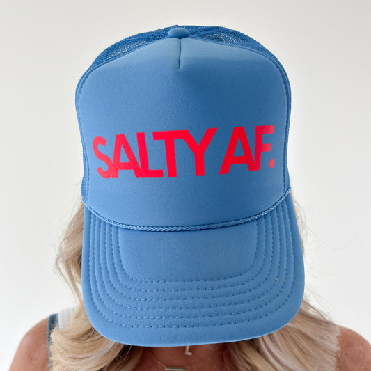 Women's bright blue high profile snap back foam trucker hat with neon coral "salty af." graphic