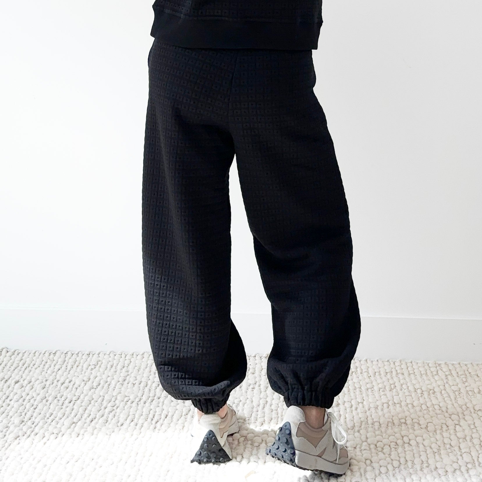 Women's black pull on drawstring elastic waist textured fabric cinched hem jogger sweatpant