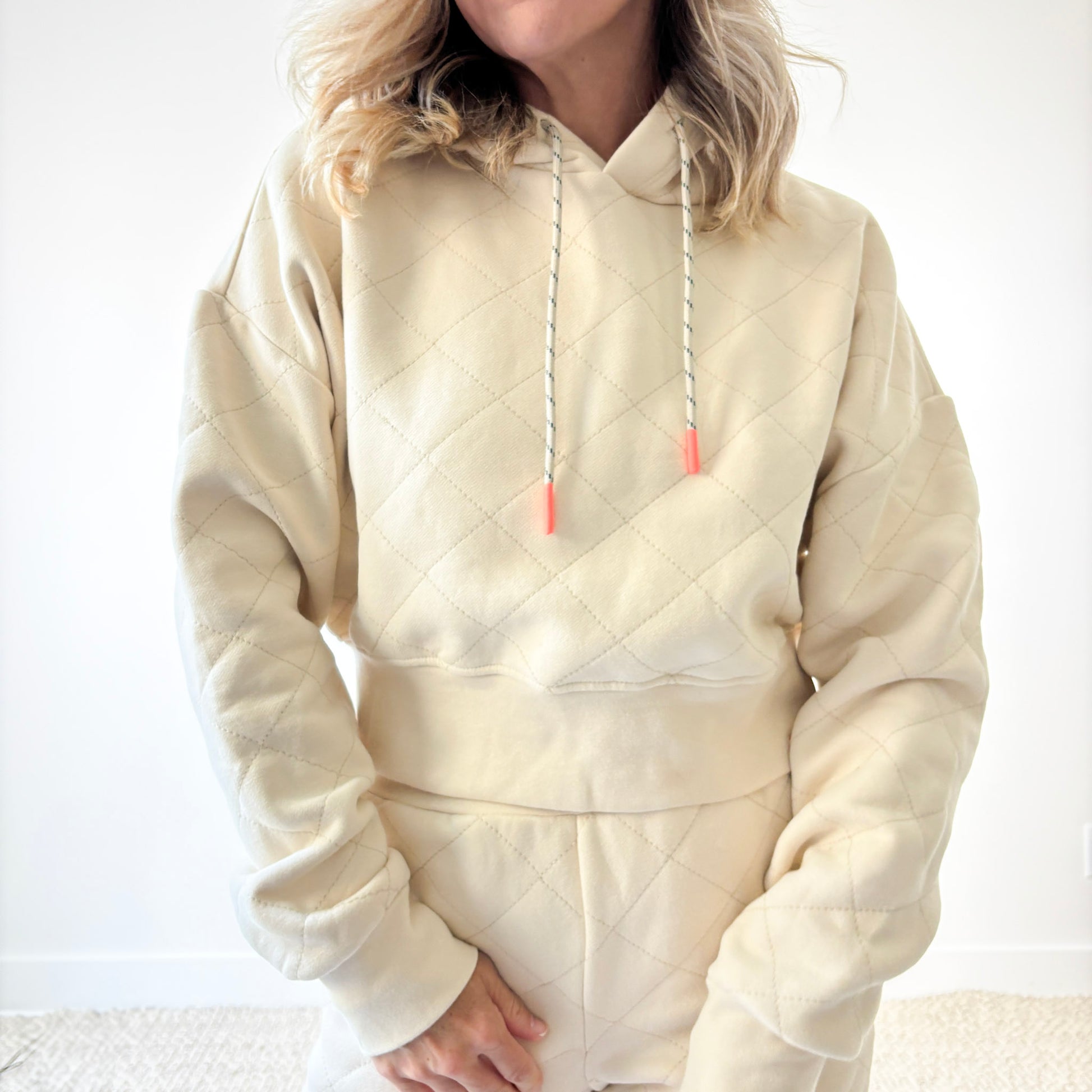 Ivory fleece quilted cropped sweatshirt with coral tipped drawcord