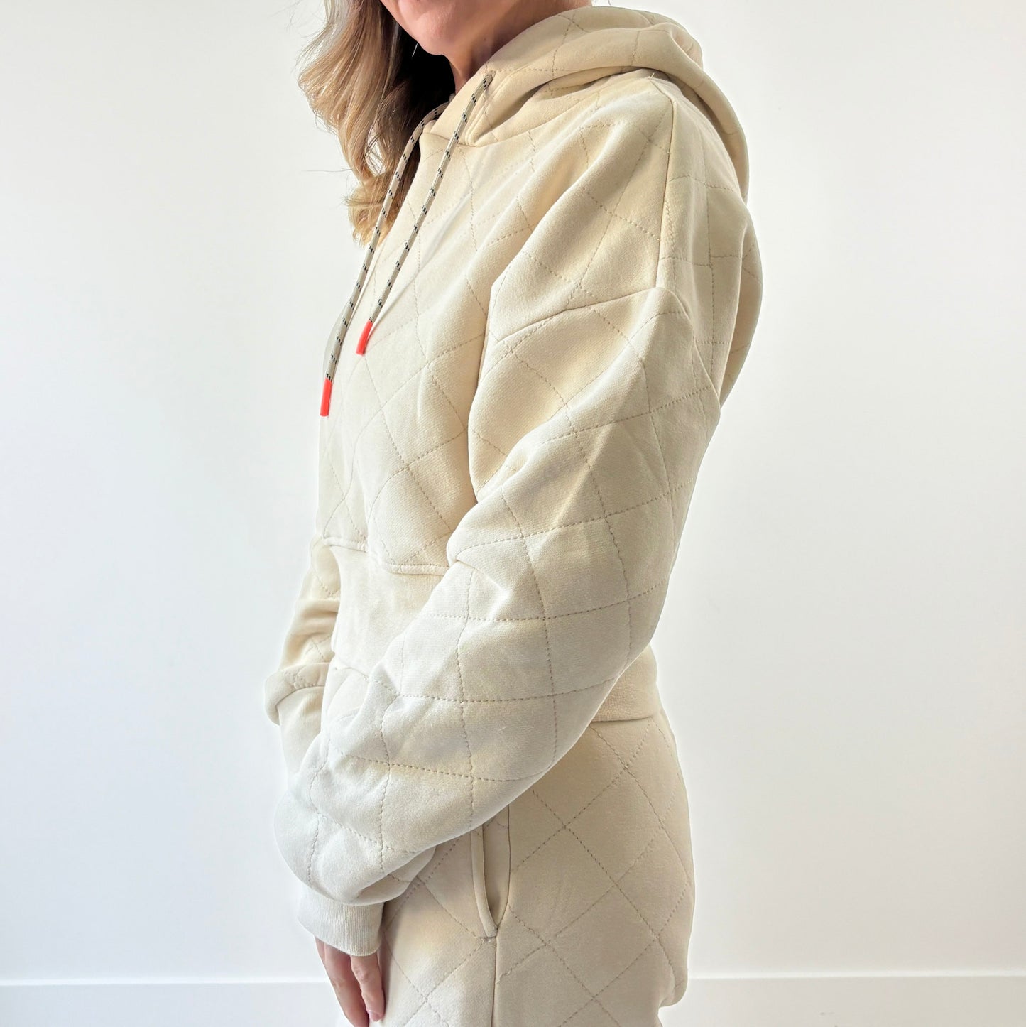 Ivory fleece quilted cropped sweatshirt with coral tipped drawcord