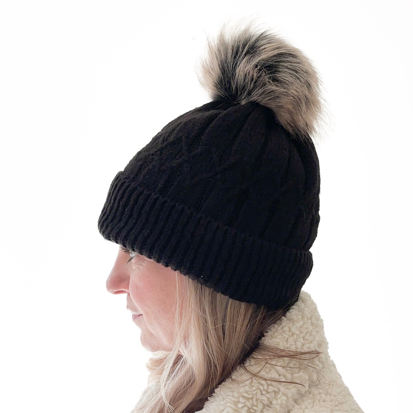 Black cuffed beanie with fair isle knit, ribbed cuff and black with tan oversized pom