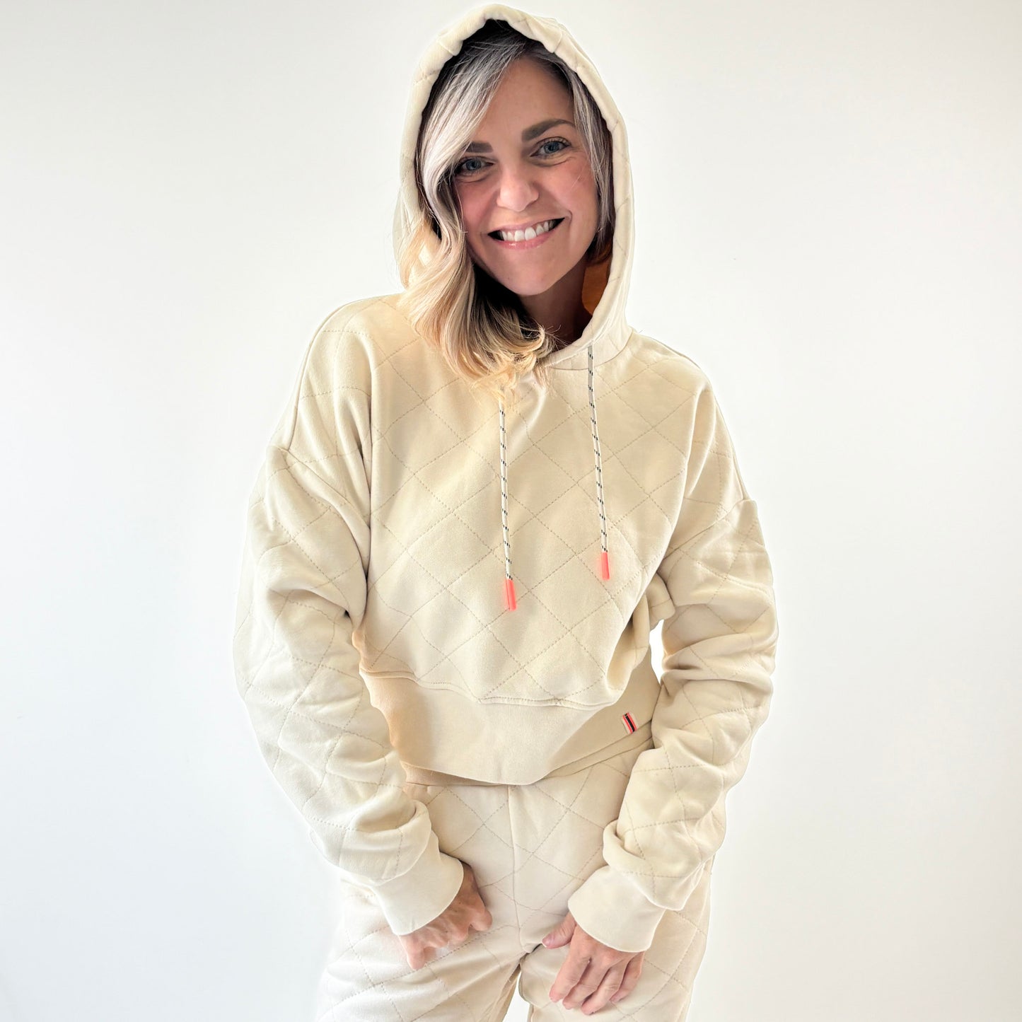 Ivory fleece quilted cropped sweatshirt with coral tipped drawcord