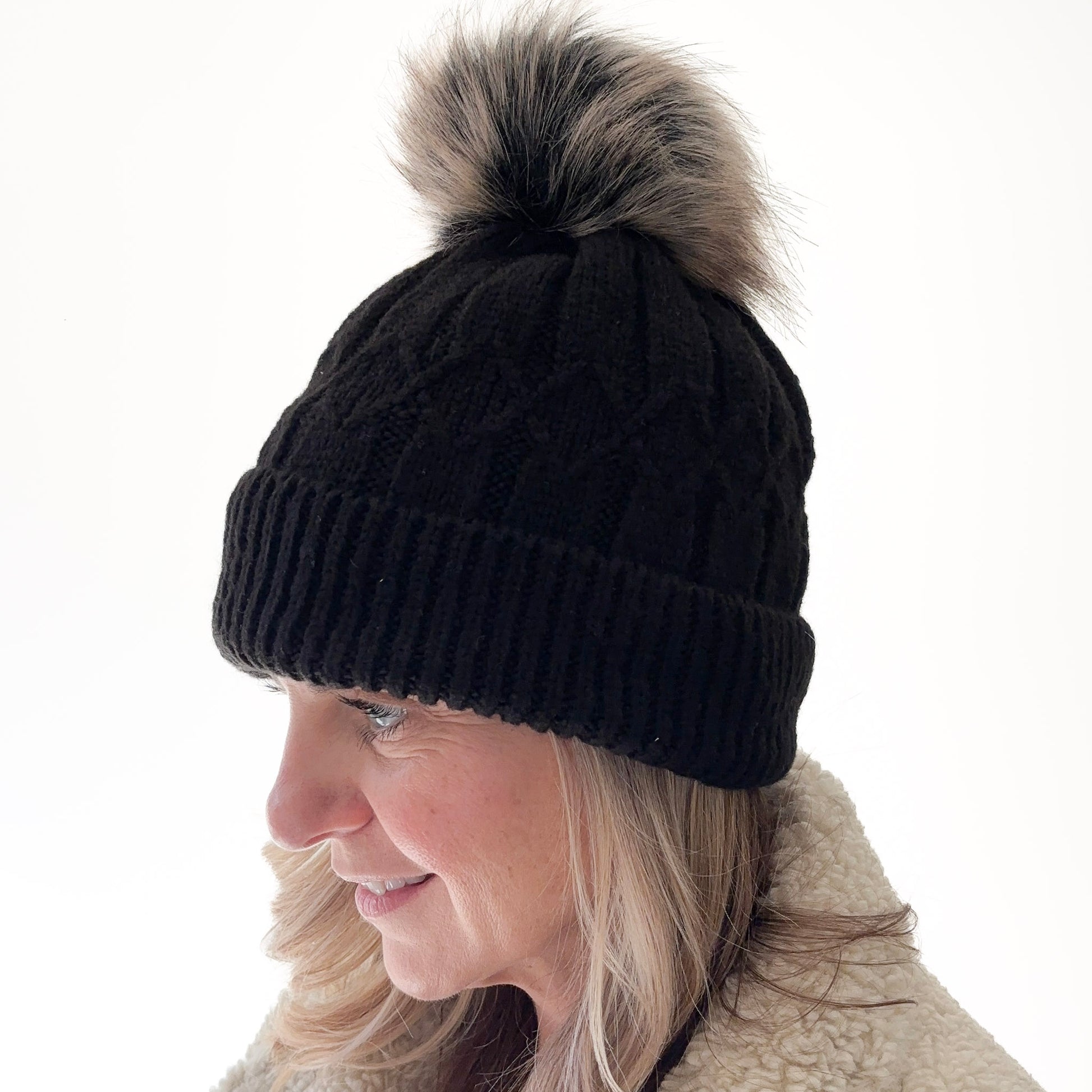 Black cuffed beanie with fair isle knit, ribbed cuff and black with tan oversized pom