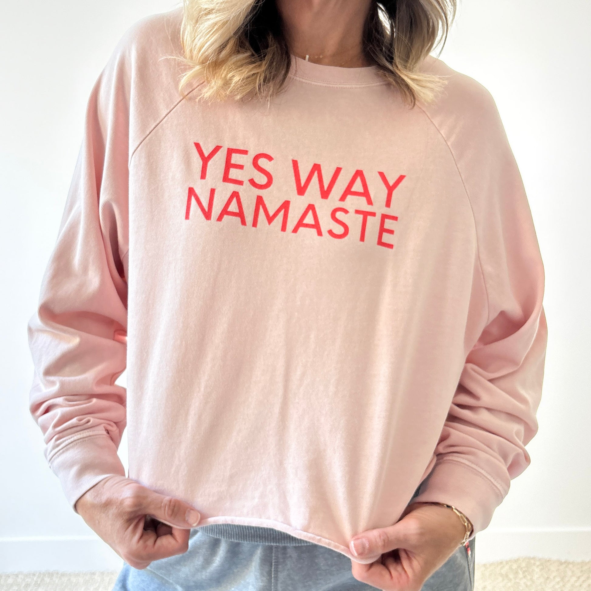 Light pink long raglan sleeve t shirt with raw hem and yes way namaste bright coral print