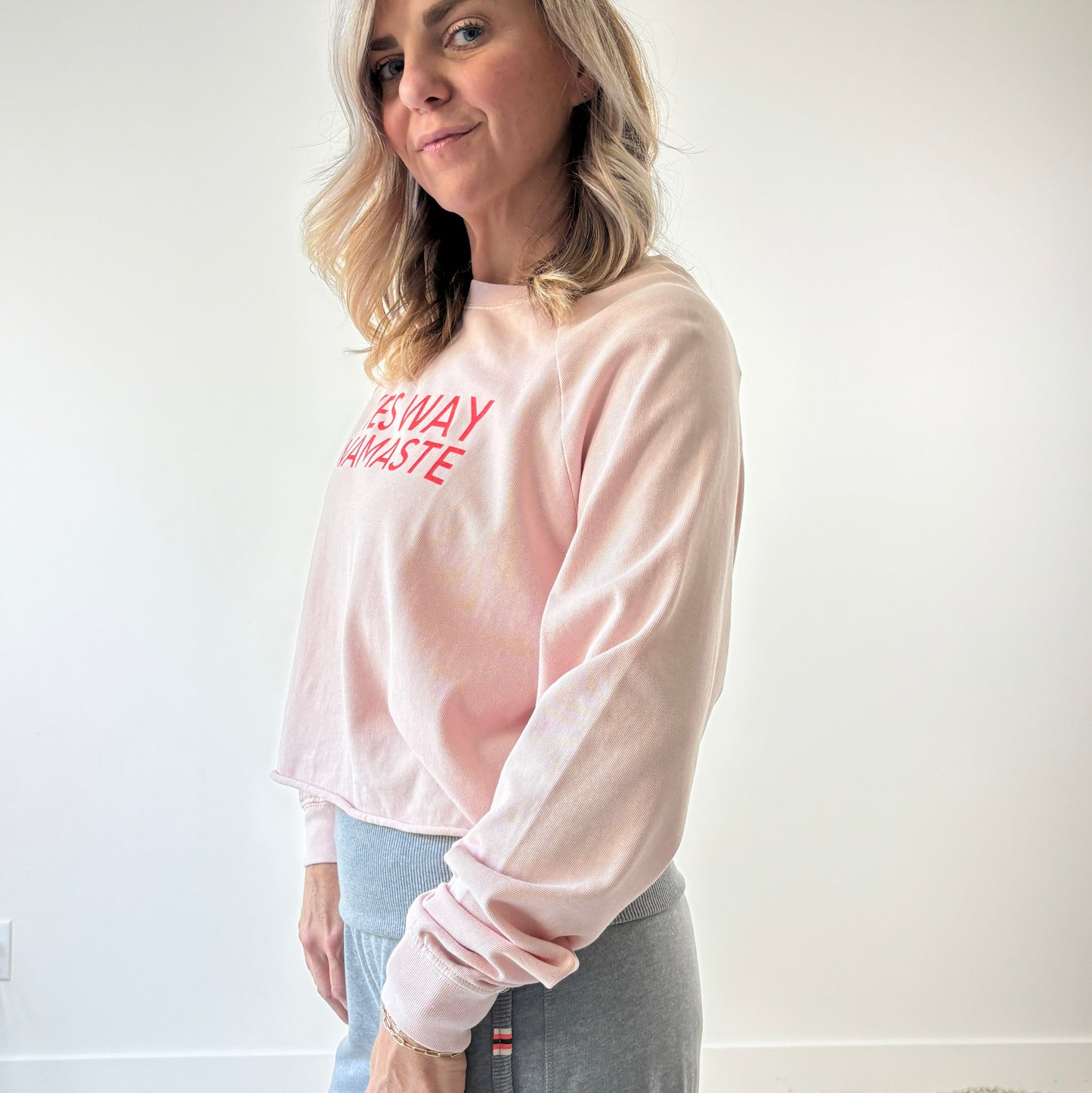 Light pink long raglan sleeve t shirt with raw hem and yes way namaste bright coral print