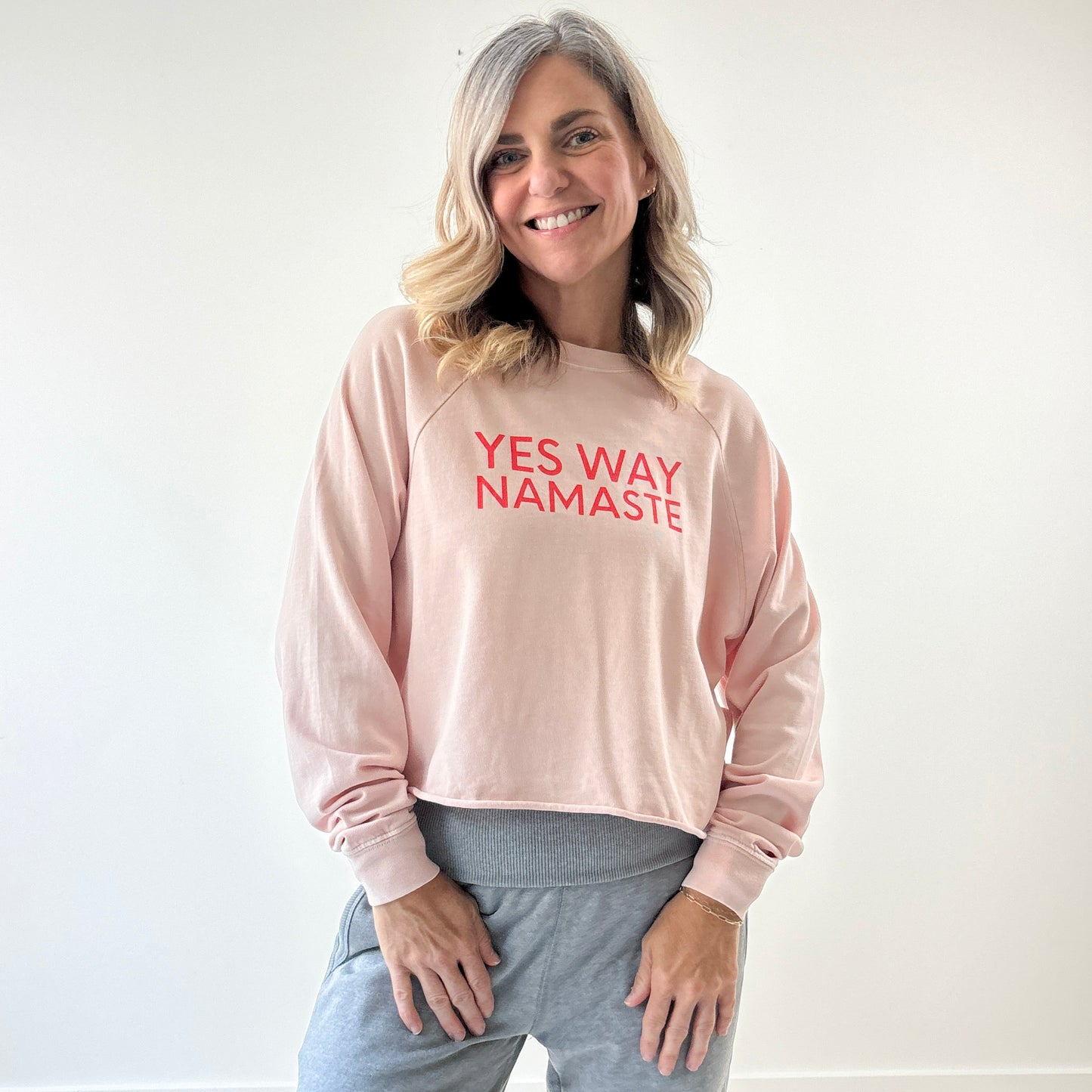 Light pink long raglan sleeve t shirt with raw hem and yes way namaste bright coral print