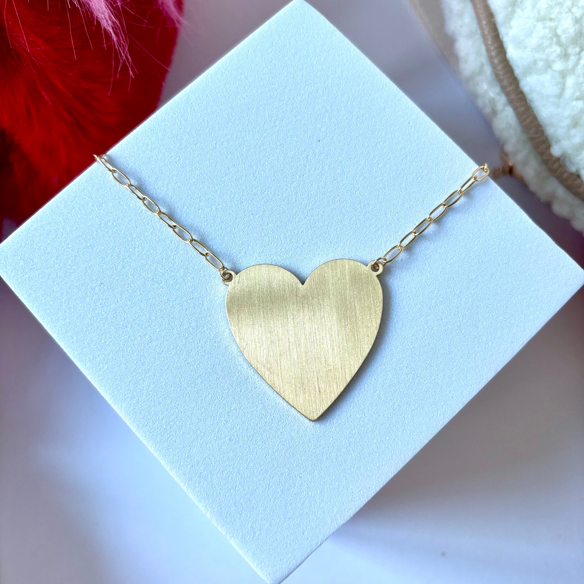 Oversized gold heart pendant necklace on linked chain