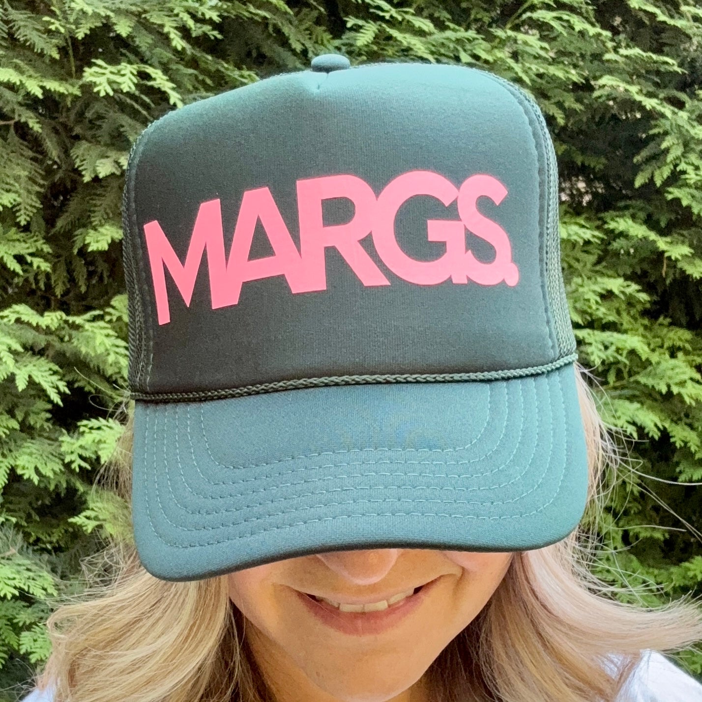 Women's dark green mind profile trucker hat with neon pink margs. print graphic