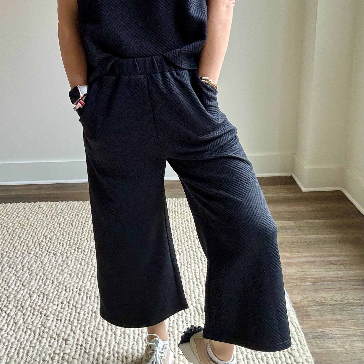 Black textured fabric pull on wide leg cropped pant with pockets