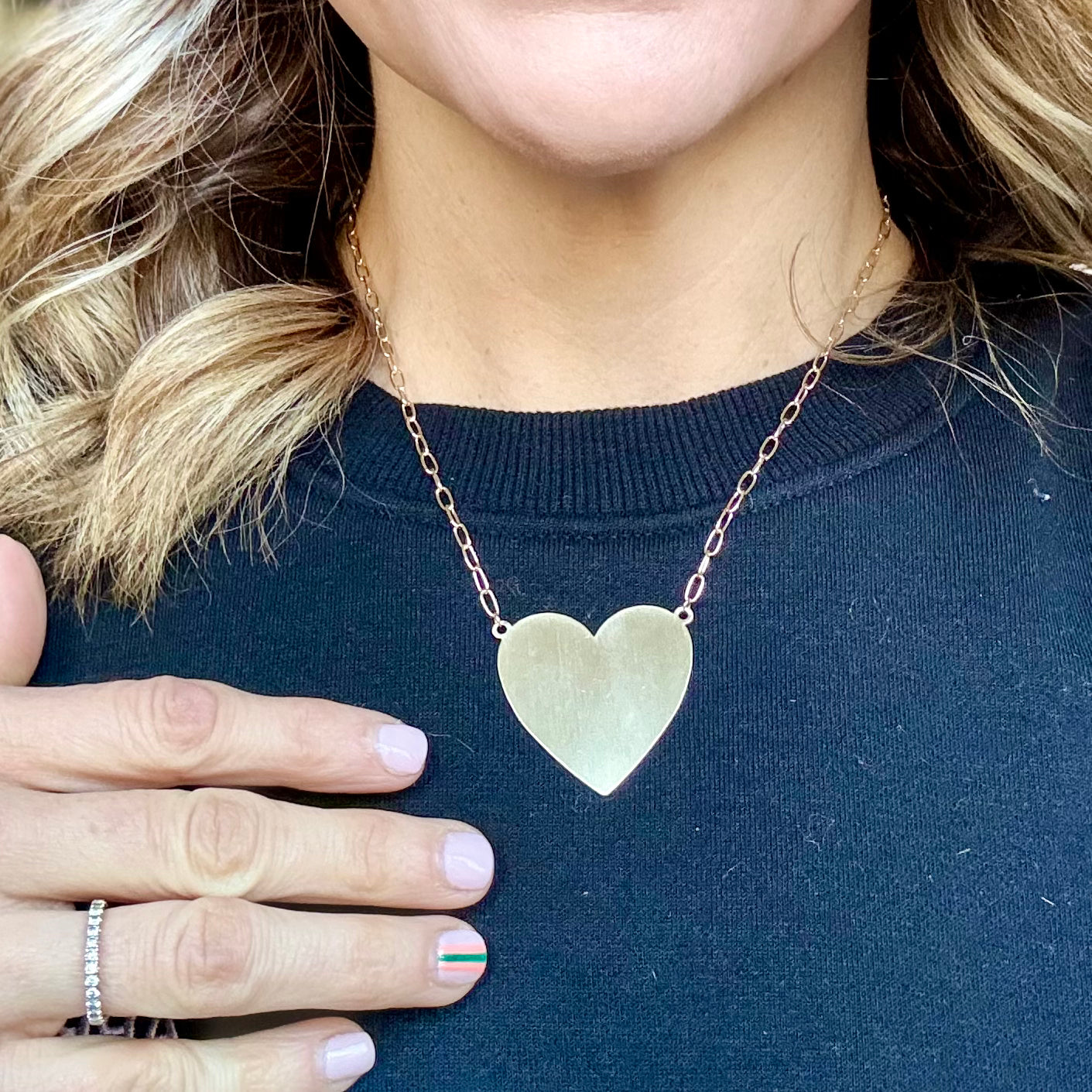 Oversized gold heart pendant necklace on linked chain